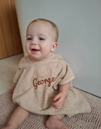 Geborduurde badponcho